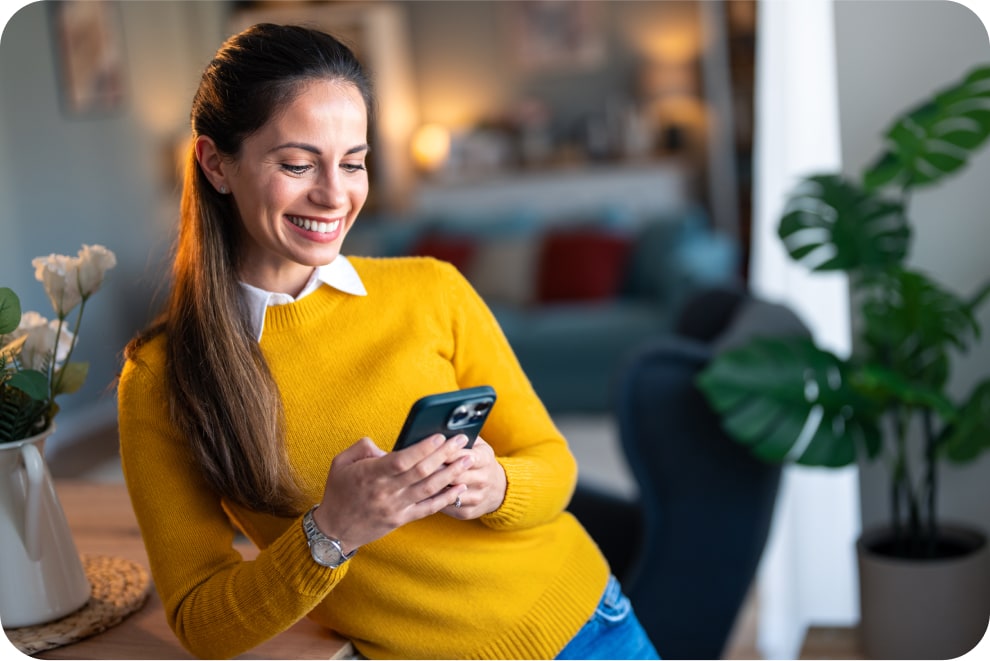 Young woman smiling while looking at the Discount Power app on her phone. 
